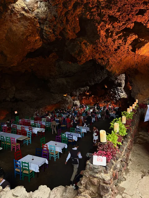 The dining room at La Gruta Teotihuacan lit by candles at night