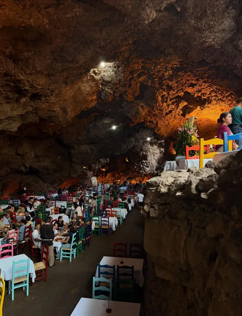 Side view of the dining room at La Gruta Teotihuacan under the rock vault