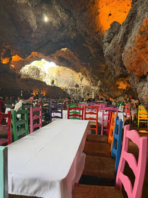 A long table with hand-painted chairs at La Gruta Teotihuacan