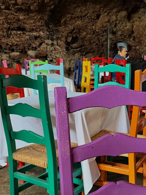 Brightly coloured handmade chairs in the dining room at La Gruta Teotihuacan